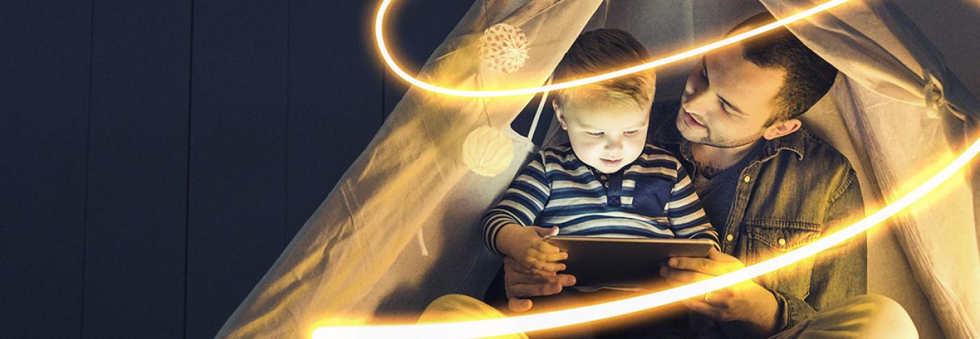 National Grid ESO - Electricity Explained homepage banner - man reading to child under tent