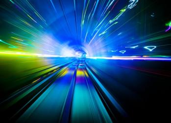 Blurred but bright image inside a train tunnel showing seemingly fast-moving lights 